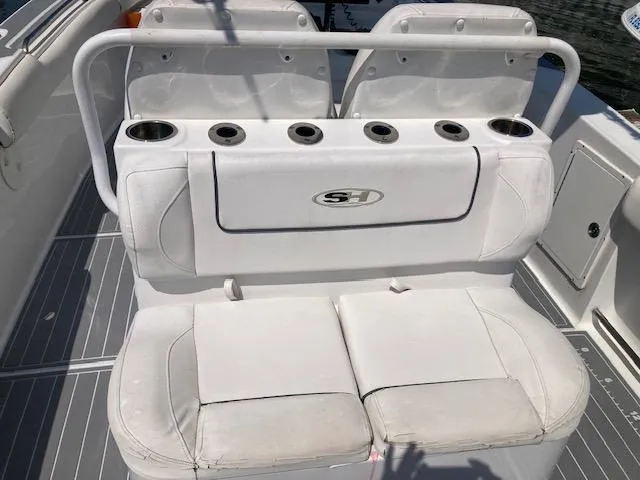 Slide: The Image of 2014 Sea Hunt Gamefish 27 boat seating with cup holders and storage. - 21