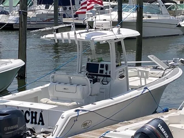 Slide: The Image of 2014 Sea Hunt Gamefish 27 boat docked, featuring a center console and Yamaha engines. - 22