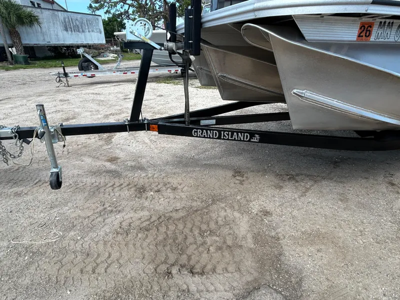 Slide: The Image of Trailer for 2024 Tahoe Pontoon 2385 TZ, parked on gravel, labeled "Grand Island." - 10