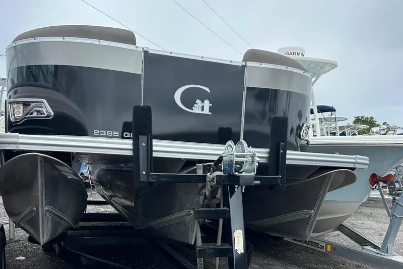 Slide: The Image of 2024 Tahoe Pontoon 2385 TZ on trailer, showcasing sleek design and modern features. - 13