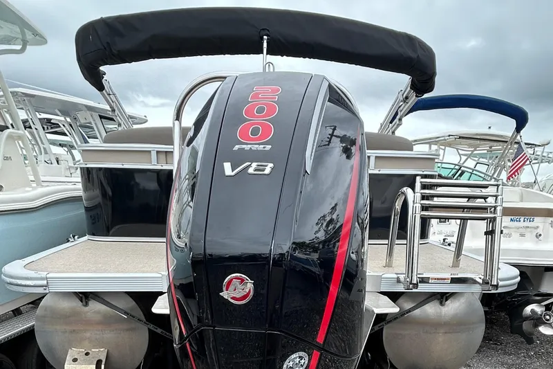 Slide: The Image of 2024 Tahoe Pontoon 2385 TZ with powerful V8 engine, docked at marina. - 14