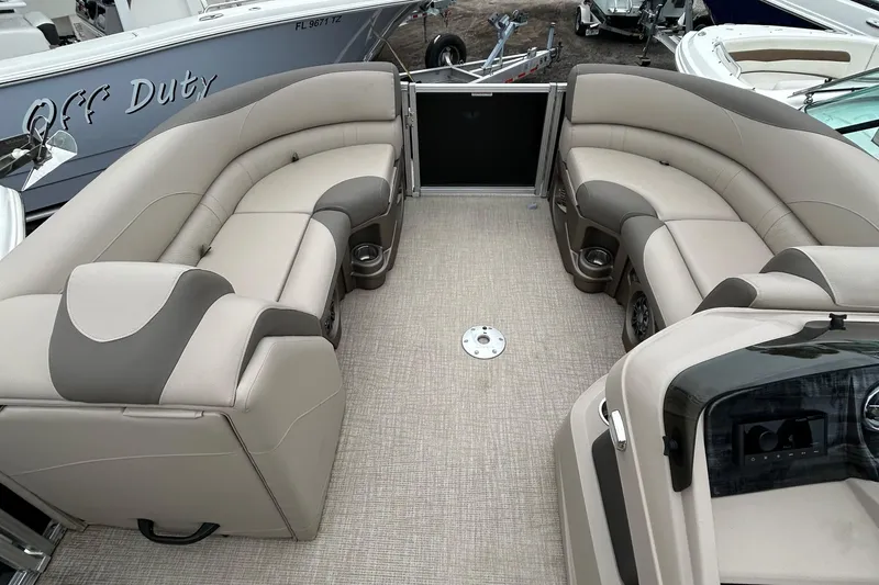 Slide: The Image of 2024 Tahoe Pontoon 2385 TZ interior with plush seating and modern design. - 20