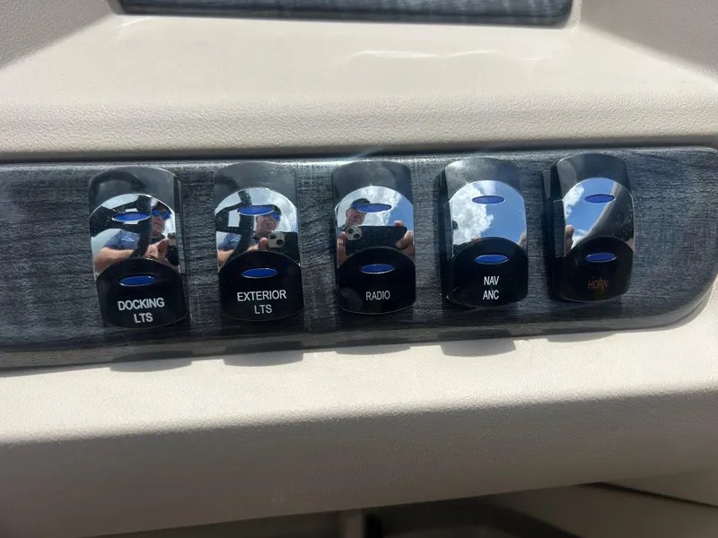 Slide: The Image of Control panel of 2024 Tahoe Pontoon 2385 TZ with labeled switches for various functions. - 22