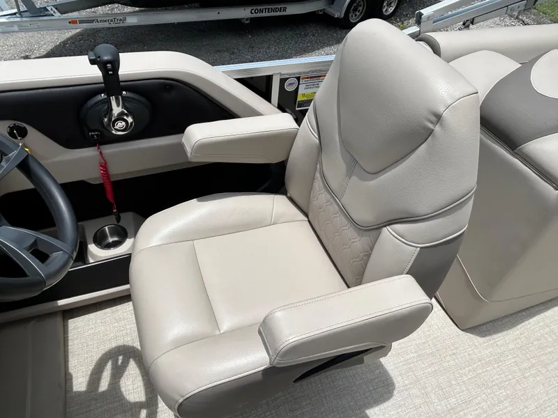 Slide: The Image of 2024 Tahoe Pontoon 2385 TZ captain's chair and helm with steering wheel and throttle. - 23