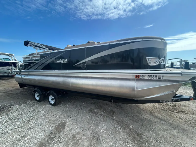 Slide: The Image of 2024 Tahoe Pontoon 2385 TZ boat on trailer under blue sky. - 7