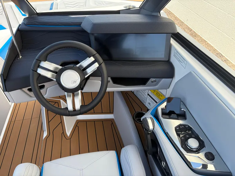 Slide: The Image of 2026 Nautique Super Air Nautique G21 helm with modern steering and control panel. - 12