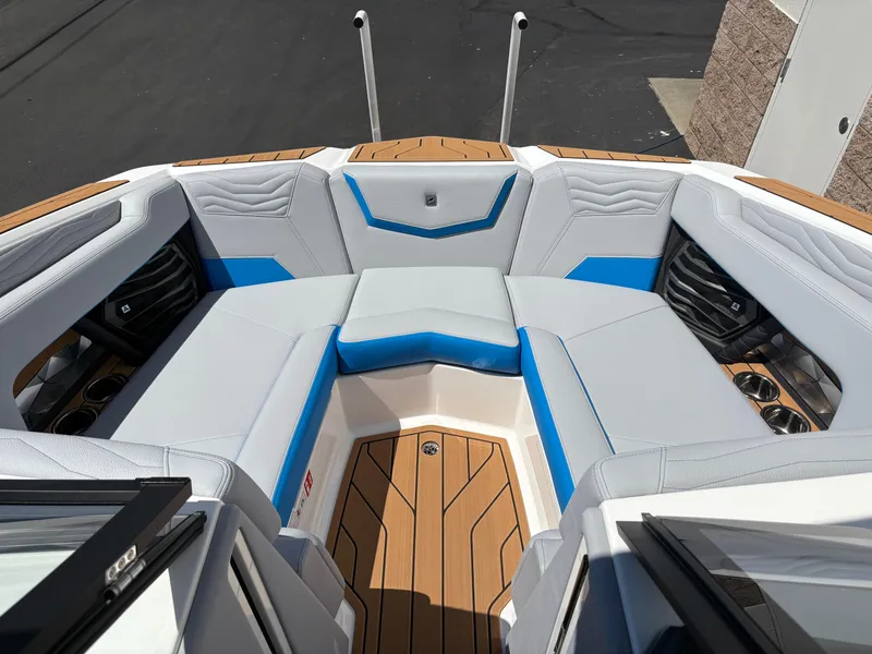 Slide: The Image of 2026 Nautique Super Air Nautique G21 boat interior with white and blue seating. - 13