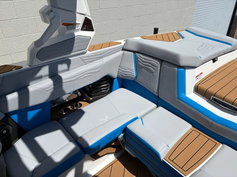 Slide: The Image of 2026 Nautique Super Air Nautique G21 interior with blue and gray seating, wood accents. - 6