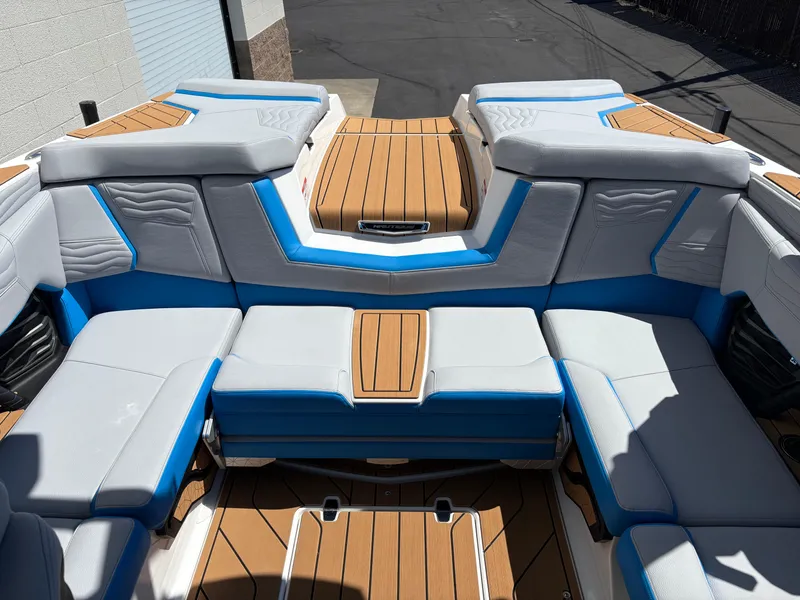 Slide: The Image of 2026 Nautique Super Air Nautique G21 interior with blue and white seating, teak accents. - 7