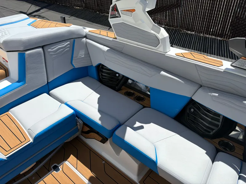 Slide: The Image of 2026 Nautique Super Air Nautique G21 interior with blue and white seating, teak accents. - 8