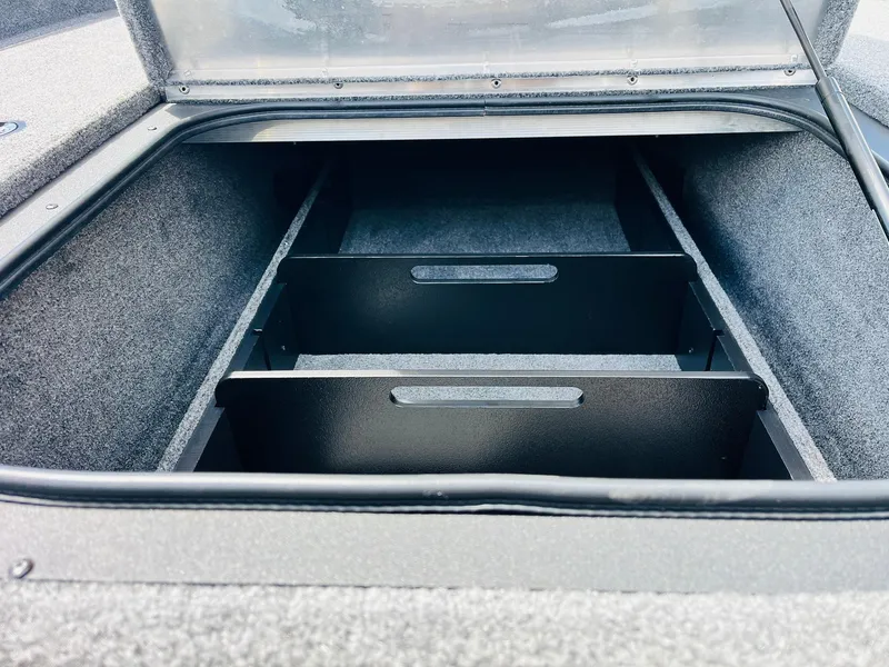 Slide: The Image of 2024 Tracker Pro Team 175 TXW storage compartment with dividers, open lid view. - 15