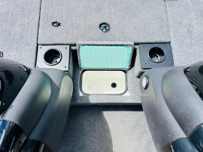 Slide: The Image of 2024 Tracker Pro Team 175 TXW boat interior with cup holders and storage compartment. - 18