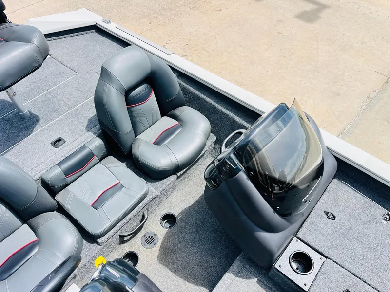 Slide: The Image of 2024 Tracker Pro Team 175 TXW boat interior with gray seating and console. - 20