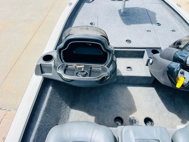 Slide: The Image of 2024 Tracker Pro Team 175 TXW boat interior with open storage compartment and seating. - 23