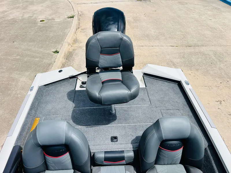 Slide: The Image of 2024 Tracker Pro Team 175 TXW boat interior with gray seating and carpeted deck. - 25