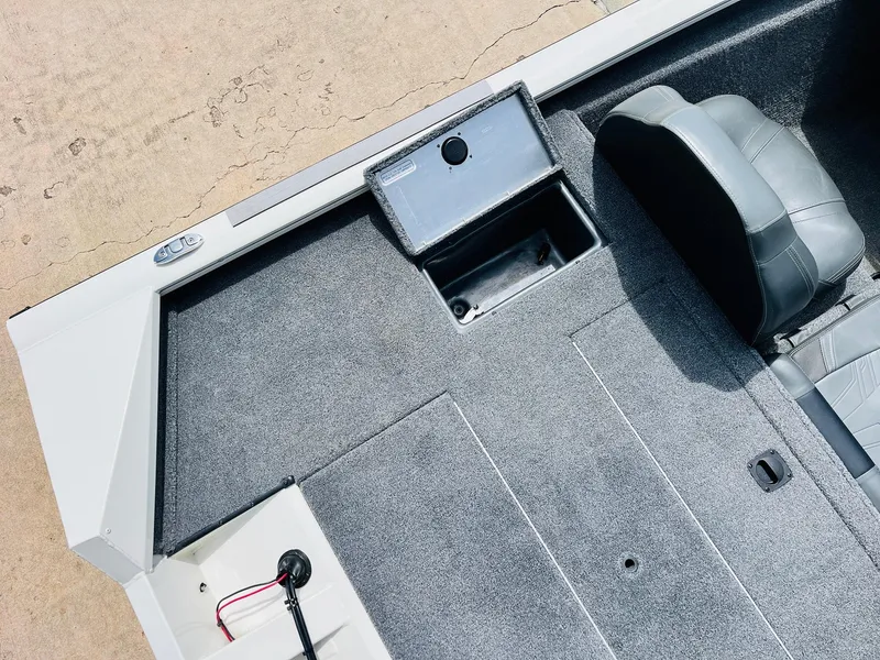 Slide: The Image of 2024 Tracker Pro Team 175 TXW boat interior with gray carpet and seating. - 29