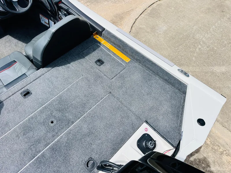 Slide: The Image of 2024 Tracker Pro Team 175 TXW boat interior with gray carpet and seating. - 30