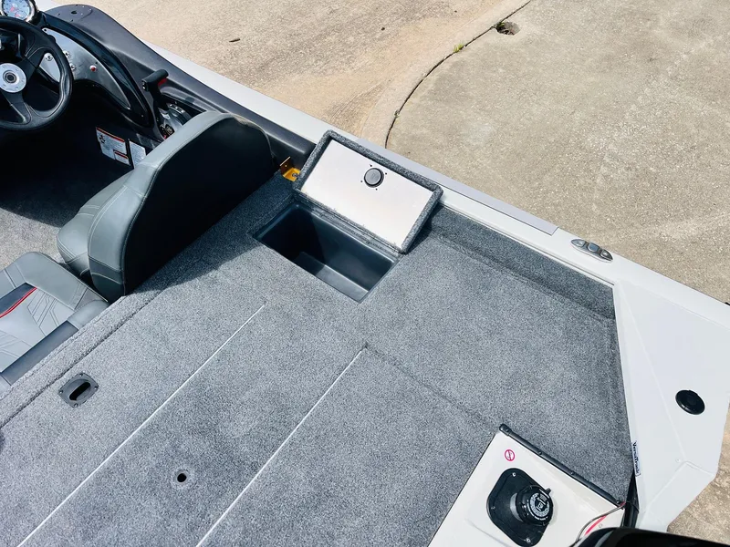 Slide: The Image of 2024 Tracker Pro Team 175 TXW boat interior with gray carpet and seating. - 31