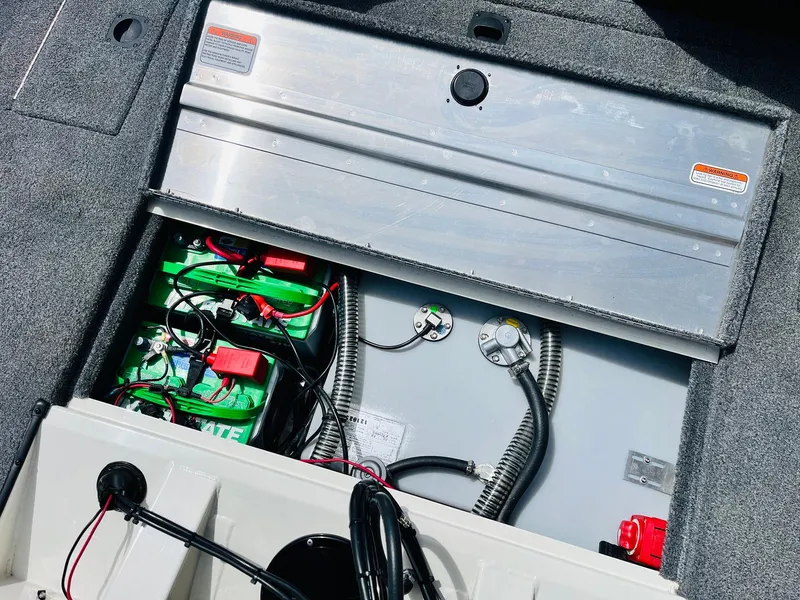Slide: The Image of 2024 Tracker Pro Team 175 TXW boat battery compartment with wiring and components. - 33