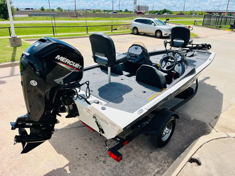 Slide: The Image of 2024 Tracker Pro Team 175 TXW boat with Mercury engine, parked outdoors on a sunny day. - 4