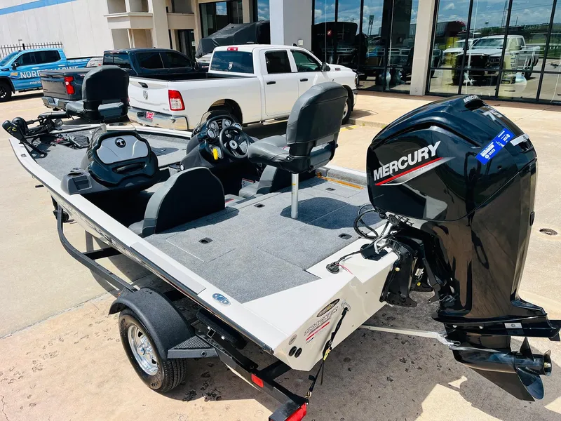 Slide: The Image of 2024 Tracker Pro Team 175 TXW boat with Mercury engine, parked outdoors. - 5