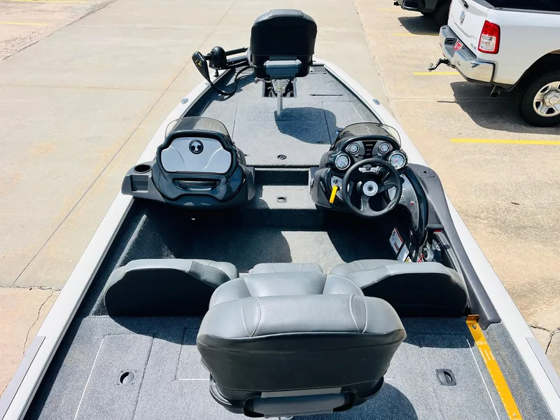 Slide: The Image of 2024 Tracker Pro Team 175 TXW boat interior with steering console and seating. - 6
