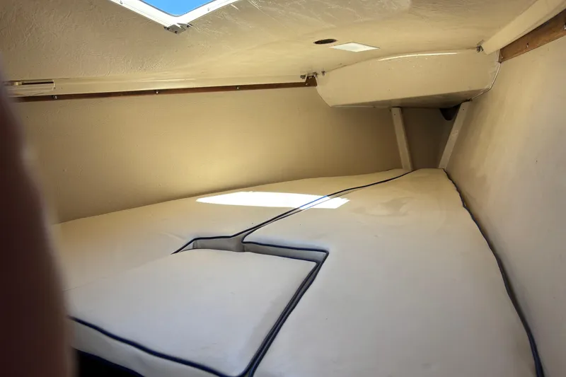 Slide: The Image of Interior cabin of a 1983 Catalina 25 sailboat with cushioned sleeping area. - 23