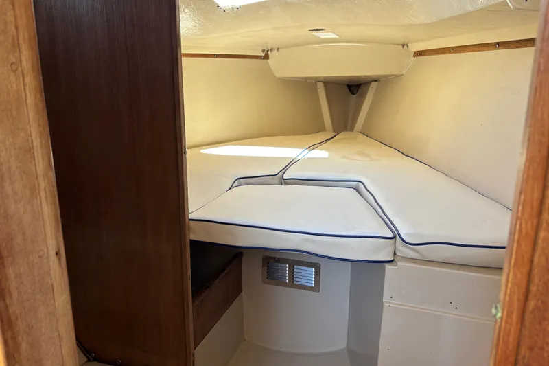 Slide: The Image of Interior cabin of a 1983 Catalina 25 sailboat with cushioned V-berth. - 25