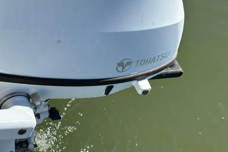 Slide: The Image of Tohatsu outboard motor on a 1983 Catalina 25 sailboat, water splashing. - 26