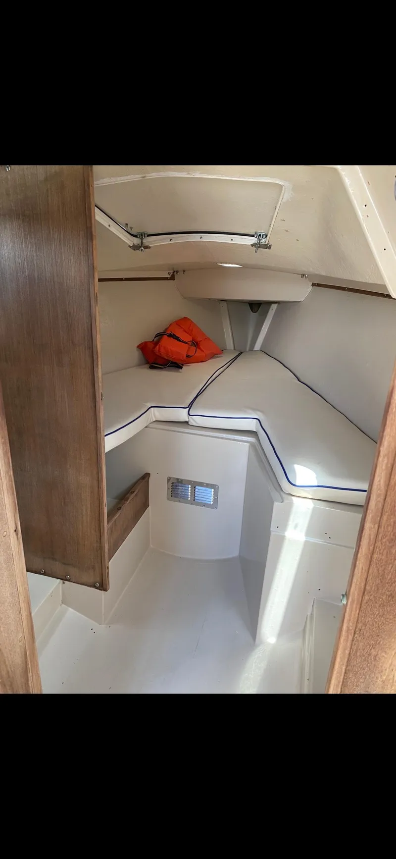Slide: The Image of Interior of 1983 Catalina 25 sailboat with cozy cabin and life jacket. - 7