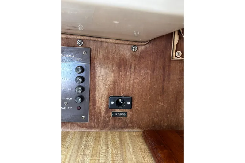 Slide: The Image of 1983 Catalina 25 sailboat interior panel with switches and 12V outlet. - 9