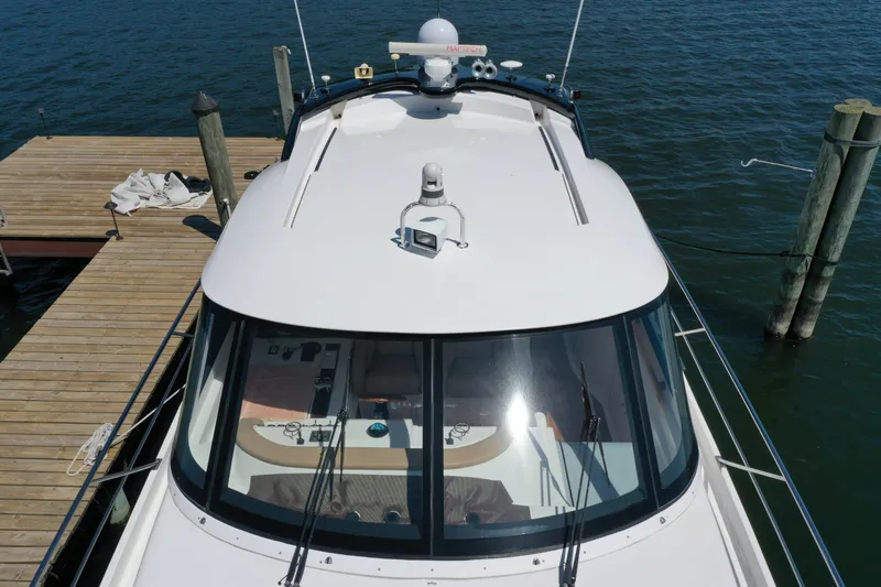 Slide: The Image of 2007 Neptunus 55 Cabrio yacht docked at a wooden pier, viewed from above. - 12