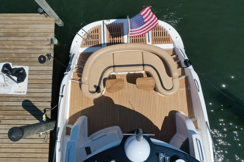 Slide: The Image of Aerial view of 2007 Neptunus 55 Cabrio yacht docked, featuring teak deck and American flag. - 13