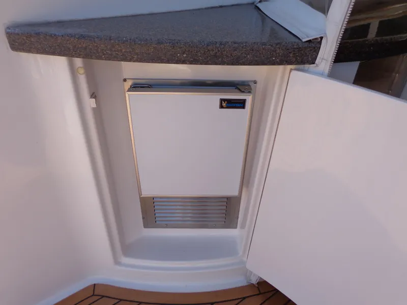 Slide: The Image of Ice maker on 2007 Neptunus 55 Cabrio yacht, under counter with open cabinet door. - 18