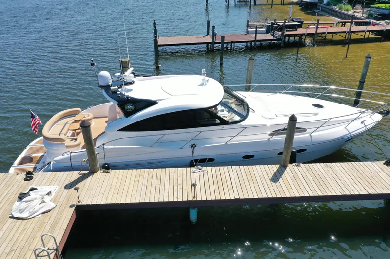 Slide: The Image of 2007 Neptunus 55 Cabrio yacht docked at a marina, viewed from above. - 2