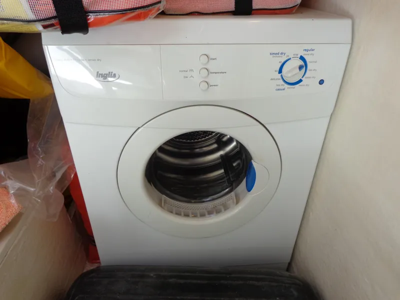 Slide: The Image of A white Inglis washing machine in a compact laundry space. - 25