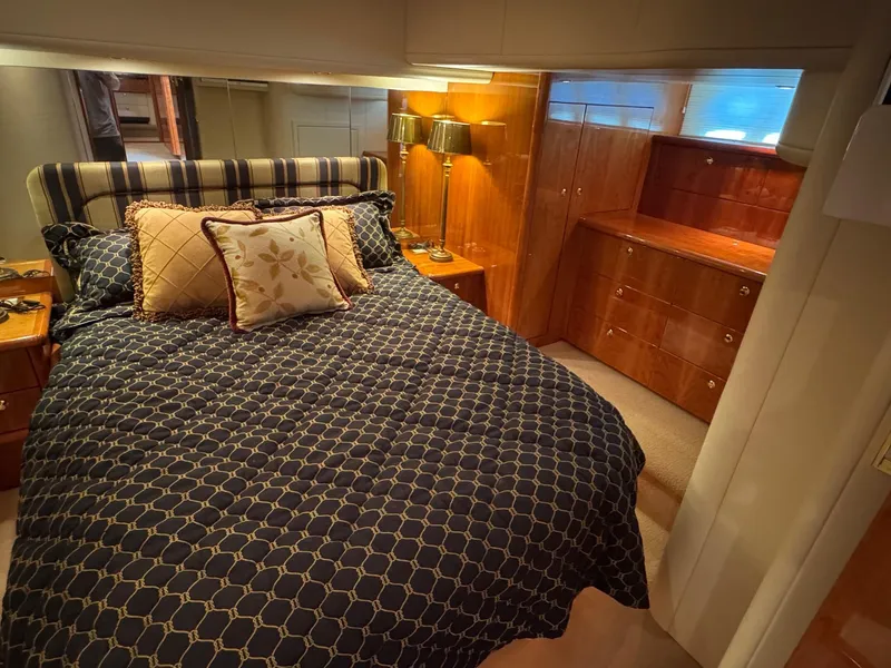 Slide: The Image of Luxurious bedroom interior of 2007 Neptunus 55 Cabrio yacht with elegant bedding and wood cabinetry. - 34