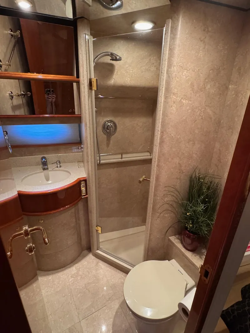 Slide: The Image of Luxurious 2007 Neptunus 55 Cabrio yacht bathroom with shower, sink, and toilet. - 36