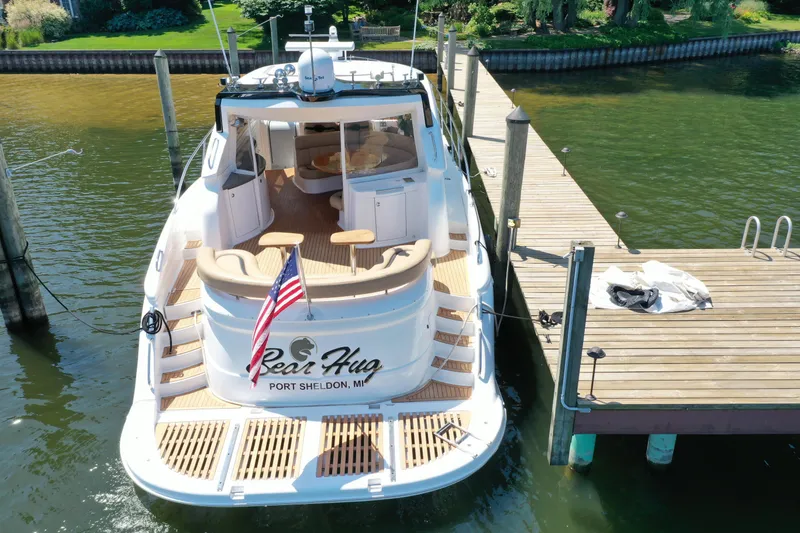 Slide: The Image of 2007 Neptunus 55 Cabrio yacht docked, rear view with American flag, sunny day. - 4
