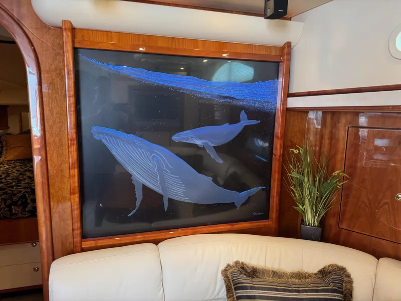 Slide: The Image of Interior of 2007 Neptunus 55 Cabrio yacht with whale artwork and elegant wood paneling. - 40