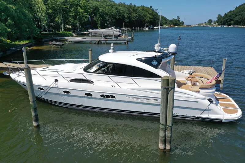 Slide: The Image of Luxury 2007 Neptunus 55 Cabrio yacht docked in serene marina setting. - 45