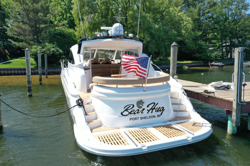 Slide: The Image of Luxury 2007 Neptunus 55 Cabrio yacht docked, featuring "Bear Hug" name and American flag. - 5