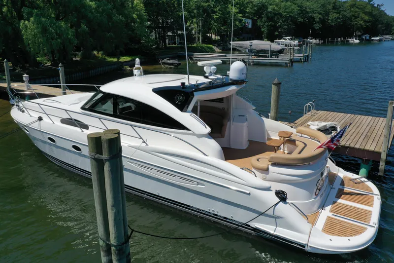 Slide: The Image of 2007 Neptunus 55 Cabrio yacht docked in a serene marina setting. - 7