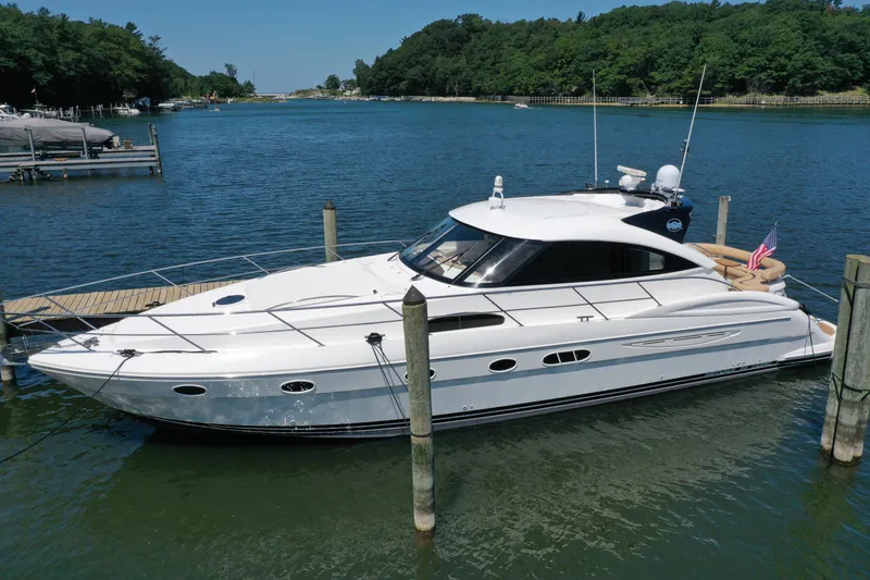 Slide: The Image of 2007 Neptunus 55 Cabrio yacht docked in a serene marina setting. - 8