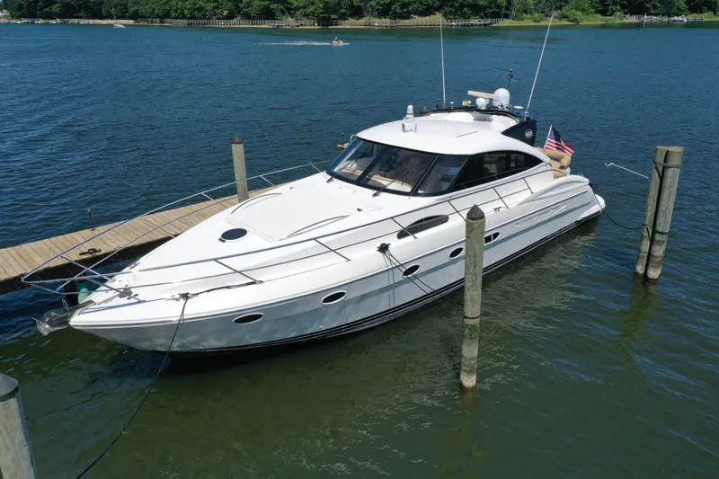 Slide: The Image of 2007 Neptunus 55 Cabrio yacht docked on a serene lake. - 9