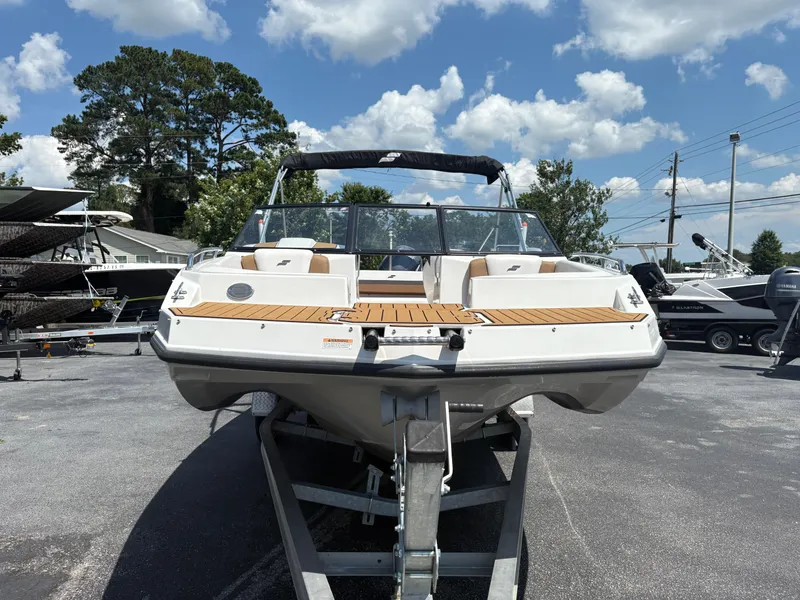 Slide: The Image of 2023 Starcraft SVX 190 OB DC boat on trailer under a sunny sky. - 10