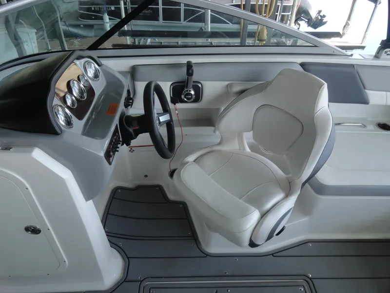 Slide: The Image of 2020 Chaparral 23 SSi boat interior with steering wheel and captain's seat. - 10
