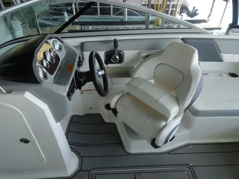 Slide: The Image of 2020 Chaparral 23 SSi boat interior with steering wheel and captain's seat. - 11