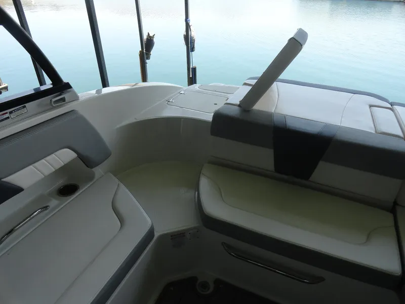 Slide: The Image of 2020 Chaparral 23 SSi boat interior with cushioned seating and cup holder. - 19