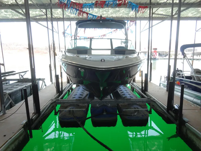 Slide: The Image of Chaparral 23 SSi 2020 boat docked in a marina with festive decorations. - 2